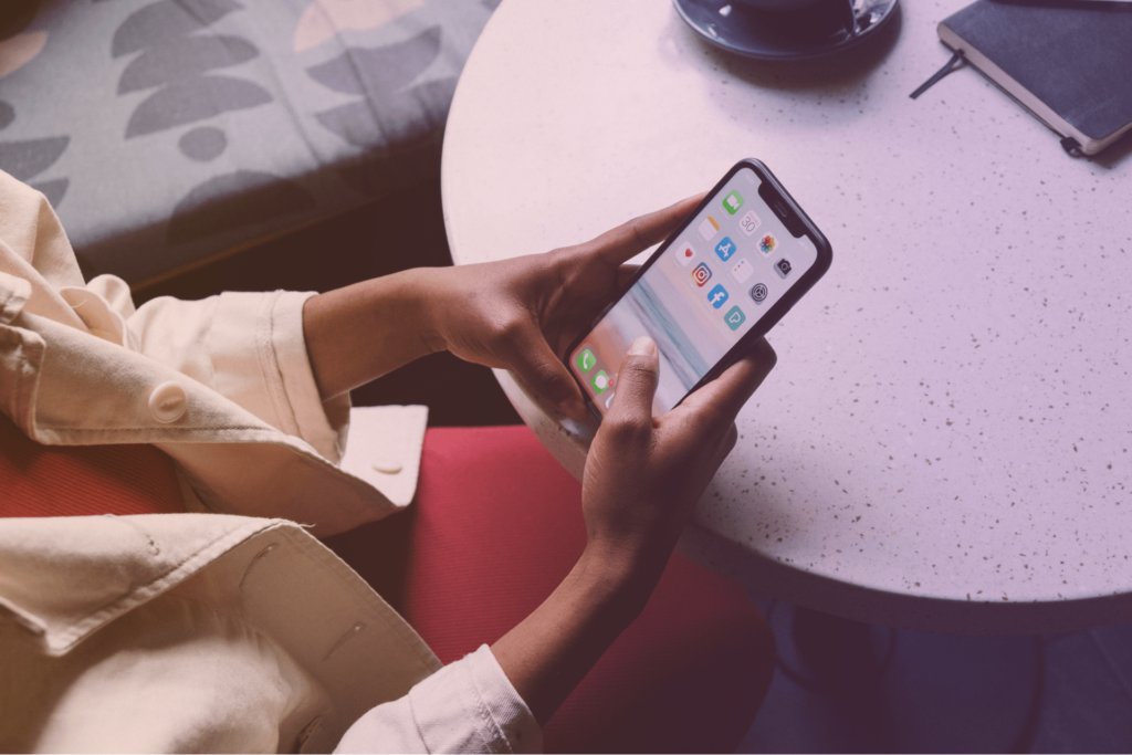 A woman holding an iPhone.